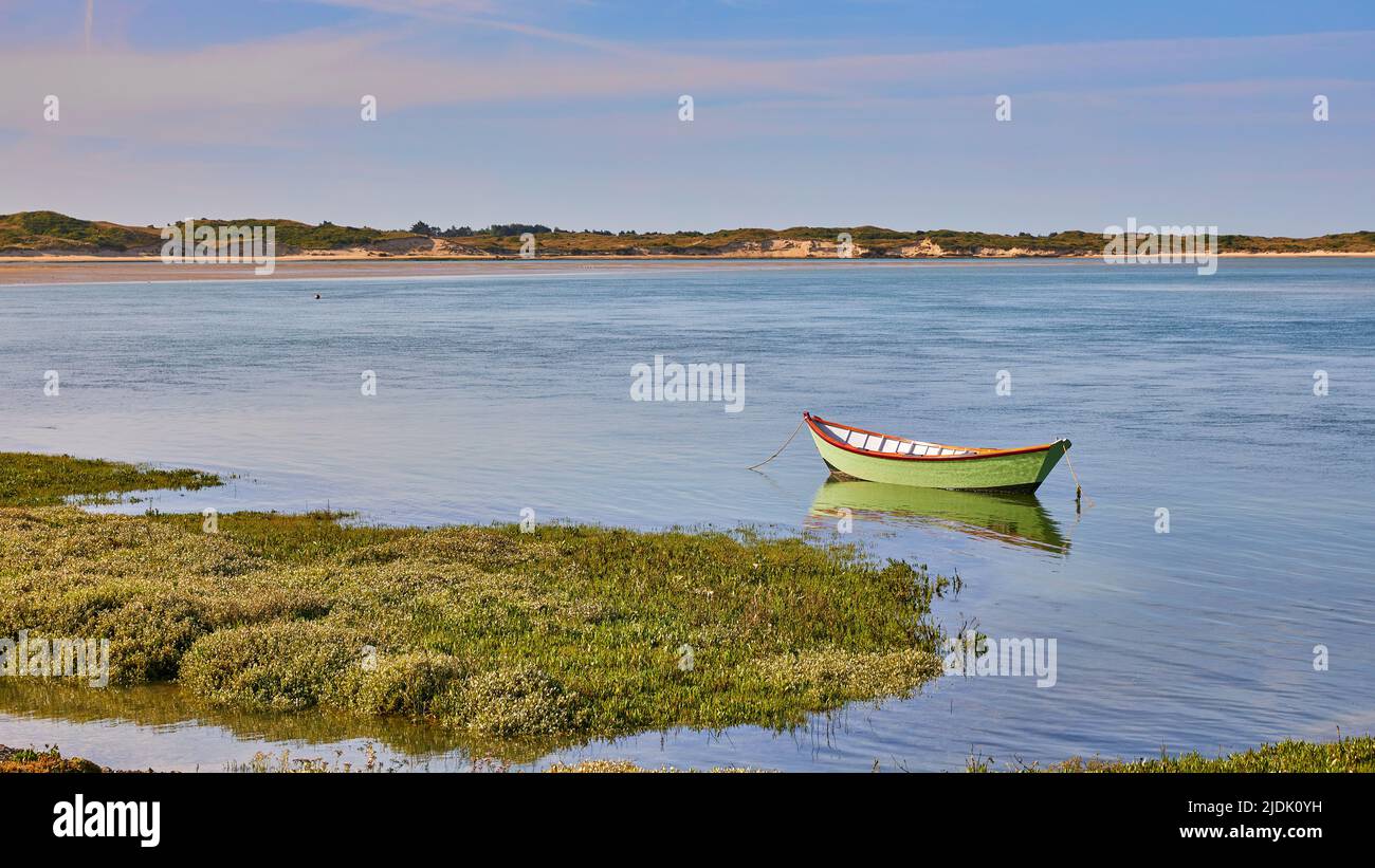 Image of the estuary at Port Bail, Fance with boat and sand dunes. Stock Photo