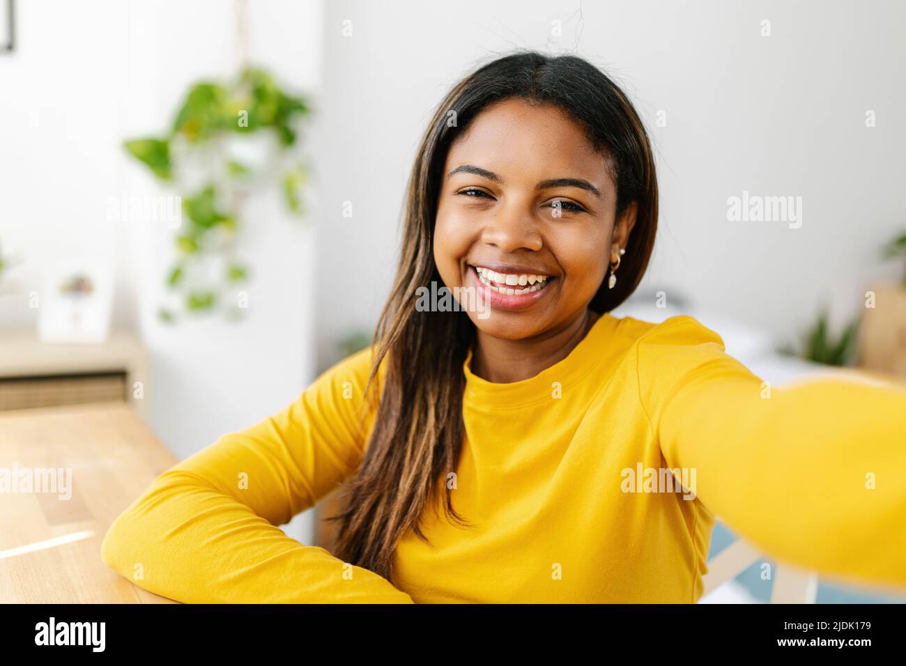 Happy young hispanic latina teenager girl taking selfie portrait with phone Stock Photo