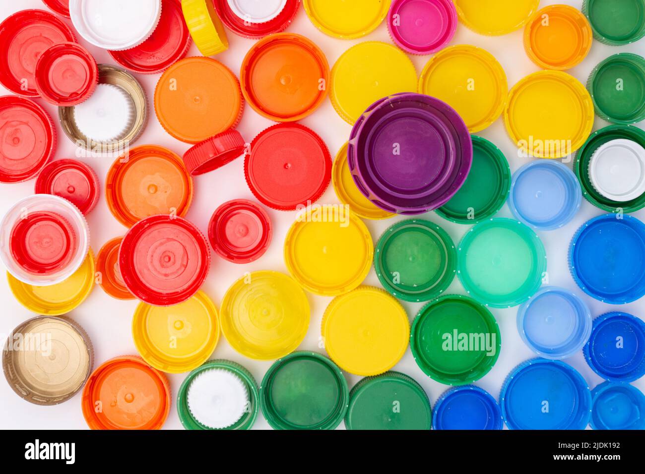 plastic bottle lid background, rainbow color, remove cap before