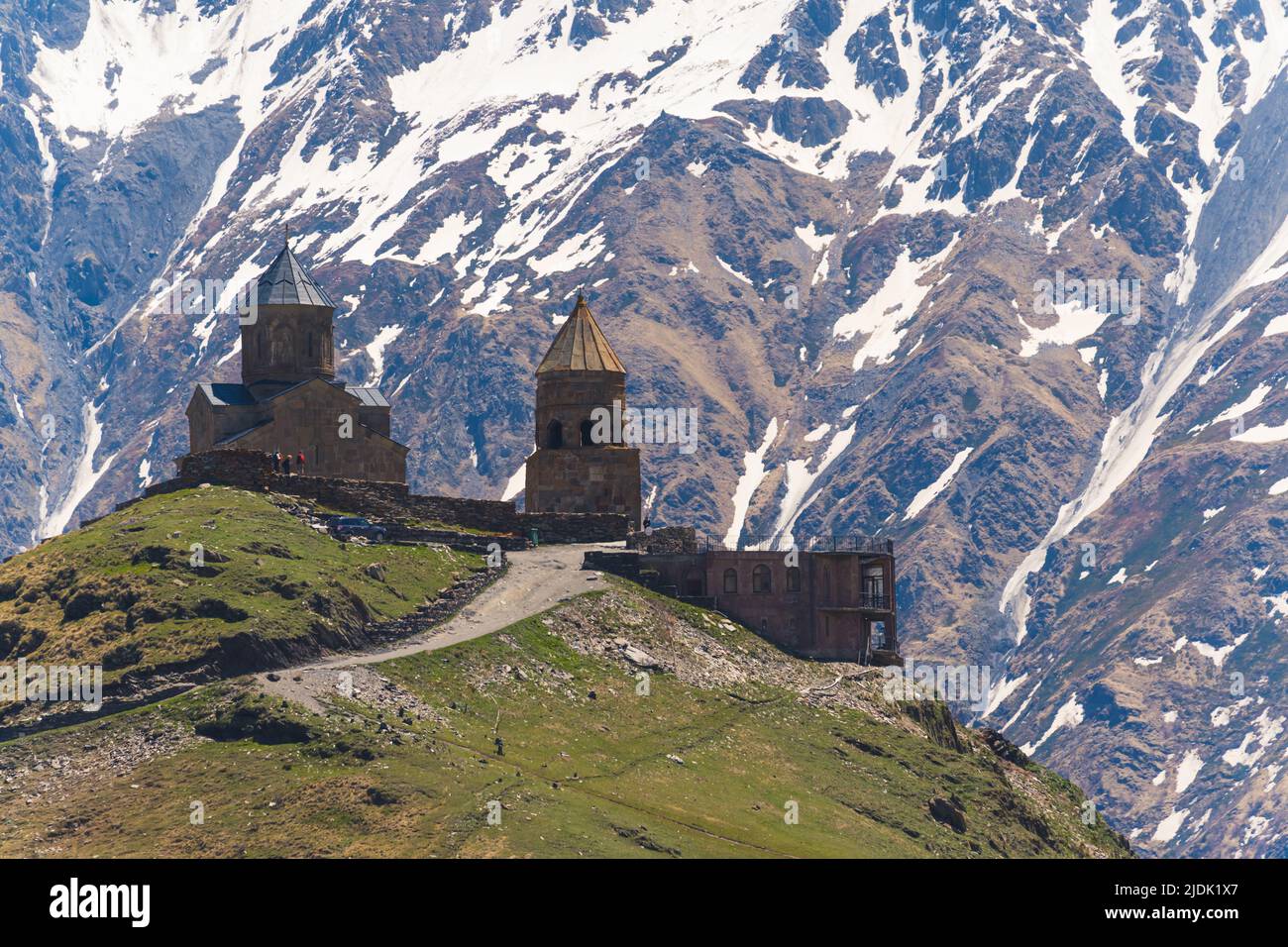 beautiful view of ancient Gergeti Trinity Church in Kazbegi, Georgia. snow-capped Caucasus mountains in the background. High quality photo Stock Photo