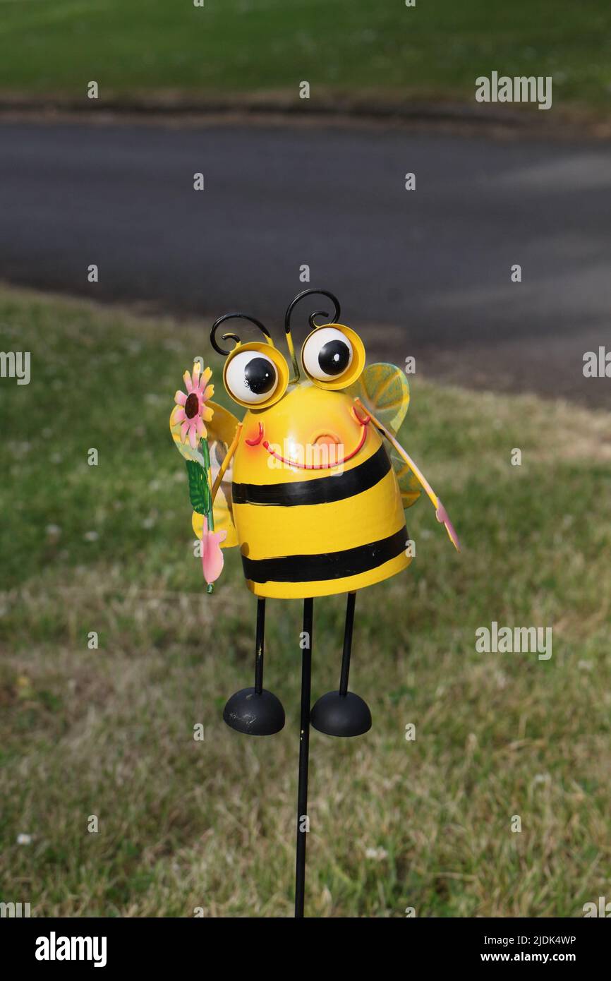 Plastic toy on stick, Bee in smiley face Stock Photo