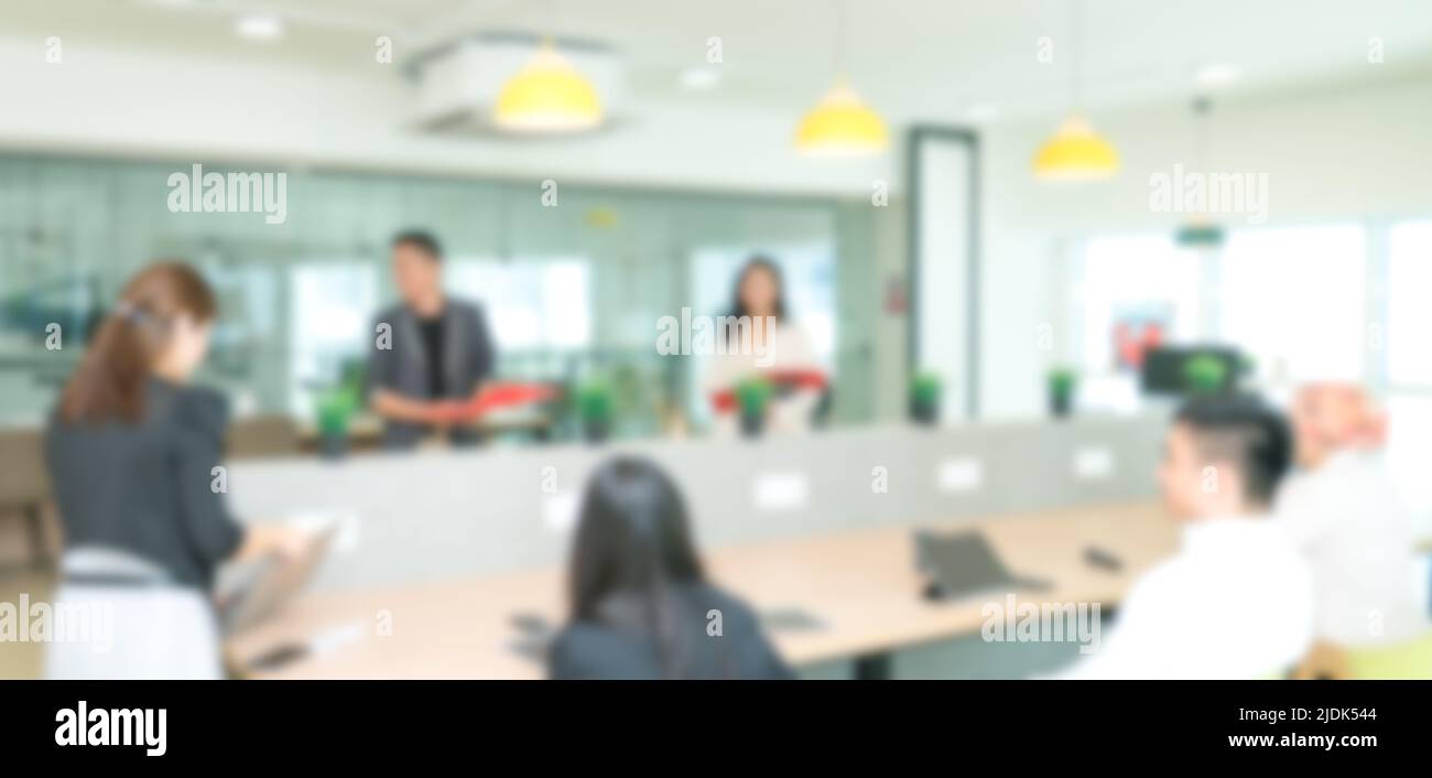 Blurred background of people meeting in office or co working space. Stock Photo
