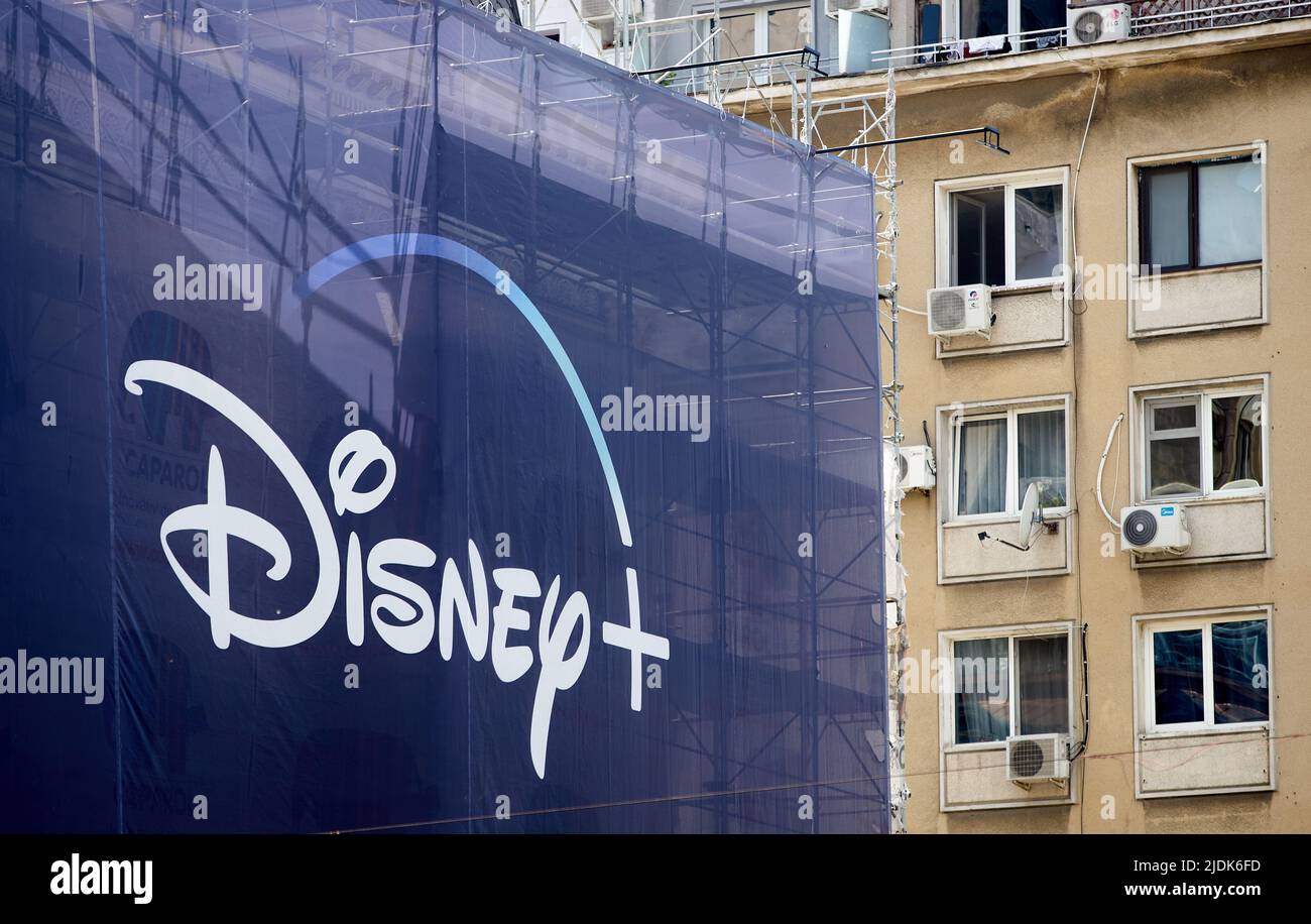 Bucharest, Romania - June 21, 2022: A Disney+ logo is displayed on an extra large banner advertising Obi-Wan Kenobi Star Wars TV Mini Series, on a bui Stock Photo