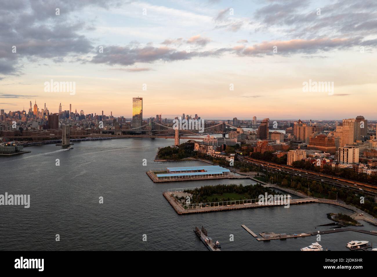 Aerial view of Manhattan in New York City from Brooklyn at sunset. Stock Photo