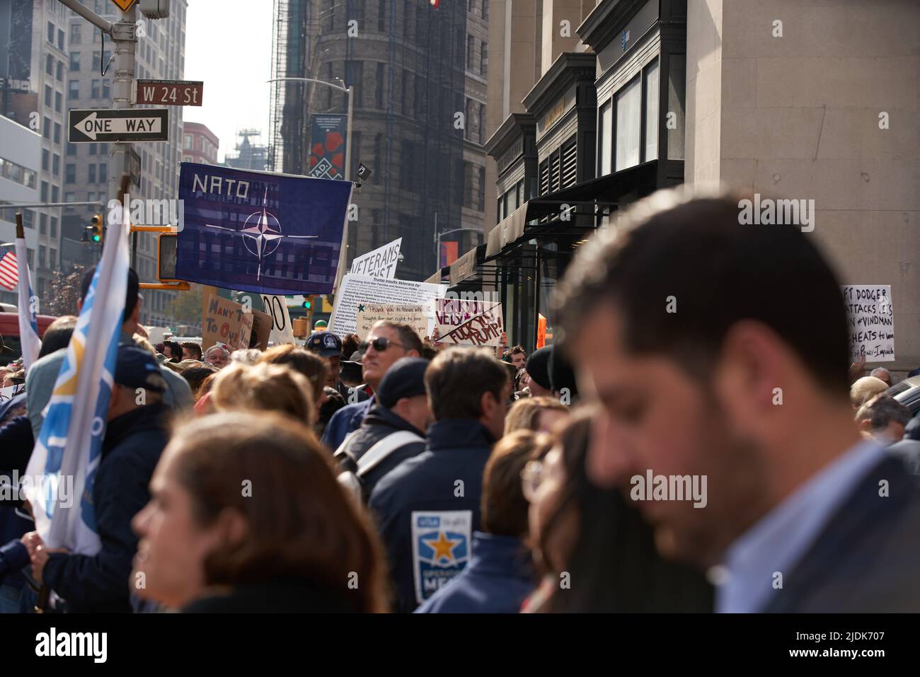 Manhattan, New York,USA - November 11. 2019: NATO flag and signs supporting Veterans during Veterans Day Parade in NYC Stock Photo