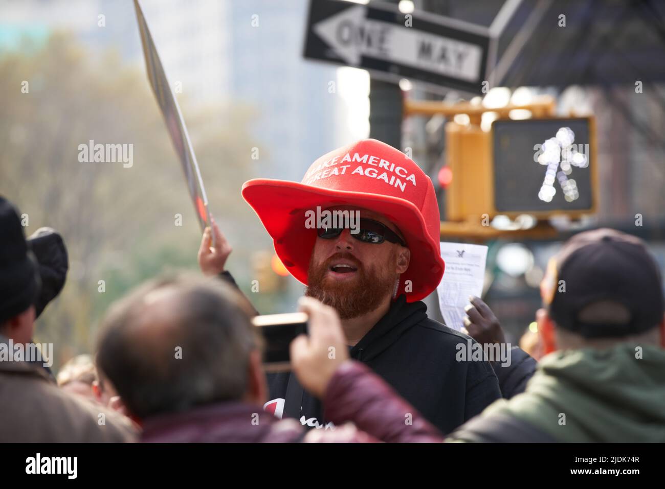 Manhattan, New York, USA - November 11. 2019: Men wearing large Make America Great Again Hat in NYC during Veterans Day Parade. Oversize MAGA Hat, red Stock Photo