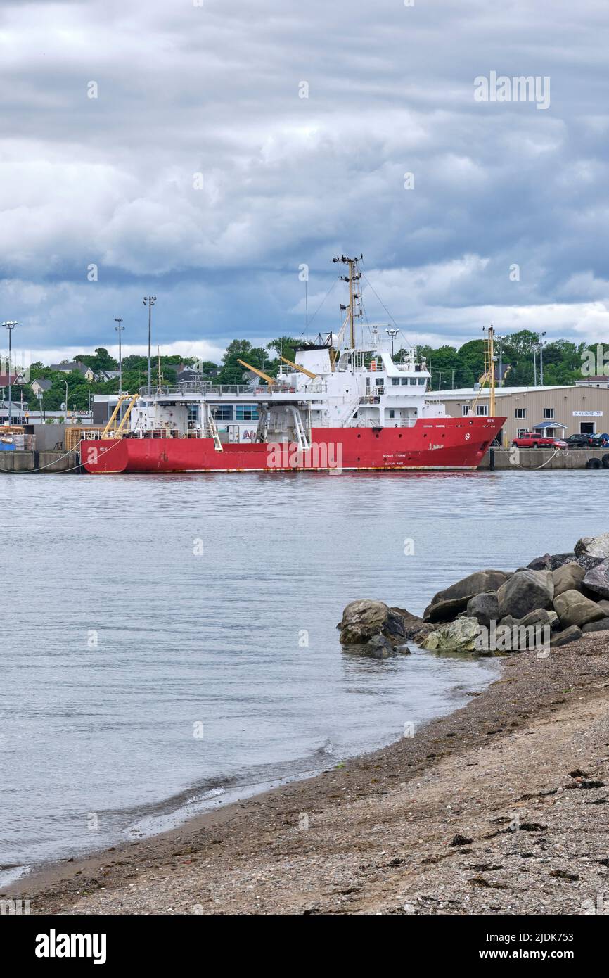 Protected harbour with a ship moored in a slip in North Sydney Cape Breton Island Nova Scotia. Stock Photo