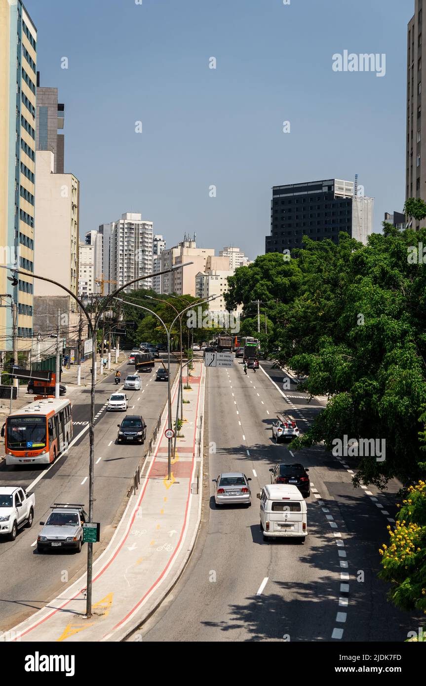 Southwest view of both ways of Antartica avenue with a bicycle lane running in the middle and normal business day traffic passing by under blue sky. Stock Photo