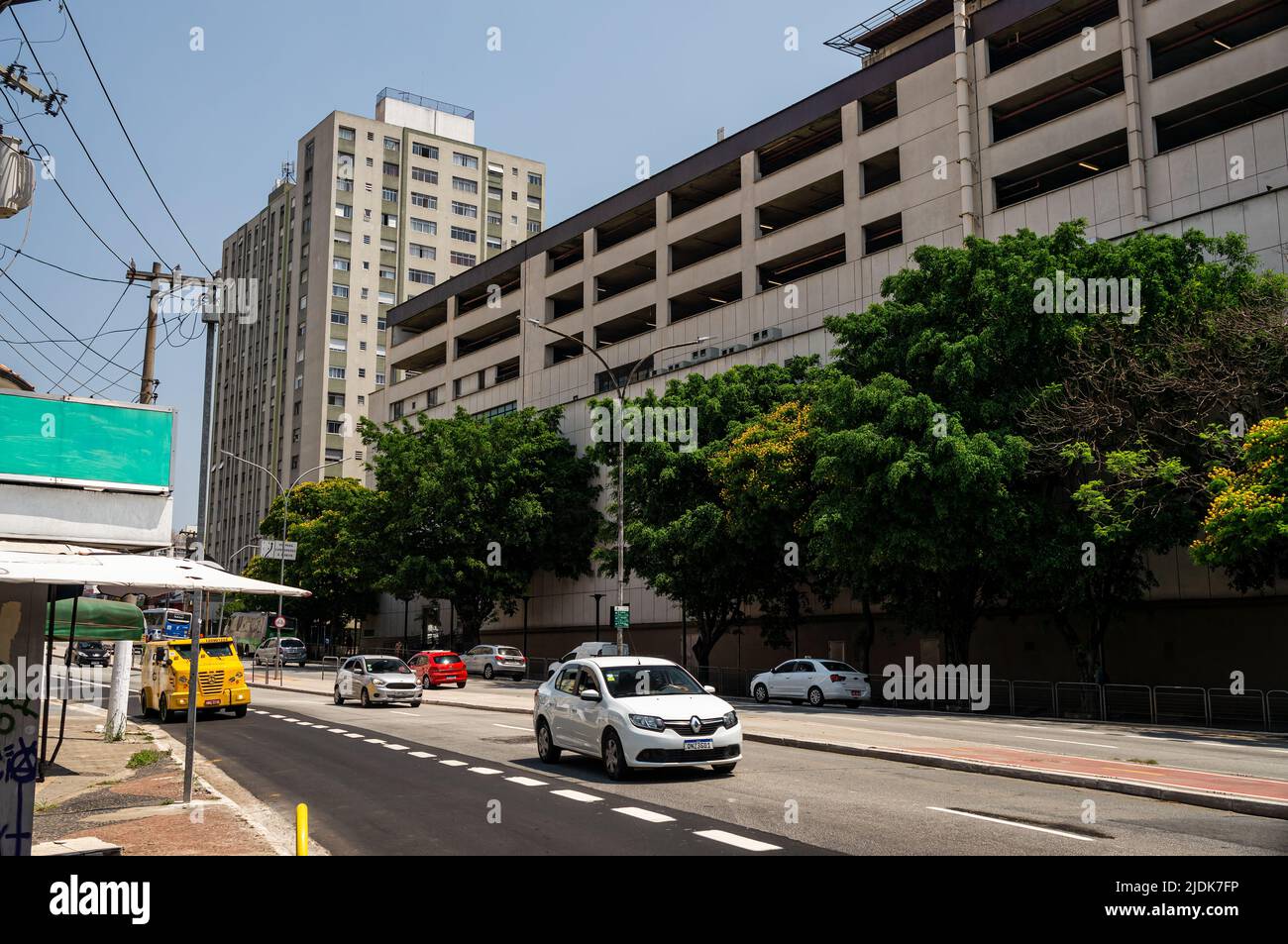Partial view of West Plaza shopping mall with normal business day Antartica avenue traffic passing by under sunny clear blue sky. Stock Photo
