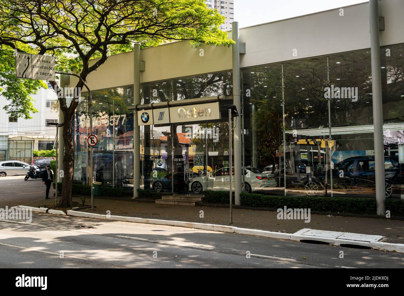 Facade of BMW Osten car dealership at the corner of Sumare avenue with Bartira street under tree shade in a normal business sunny day. Stock Photo