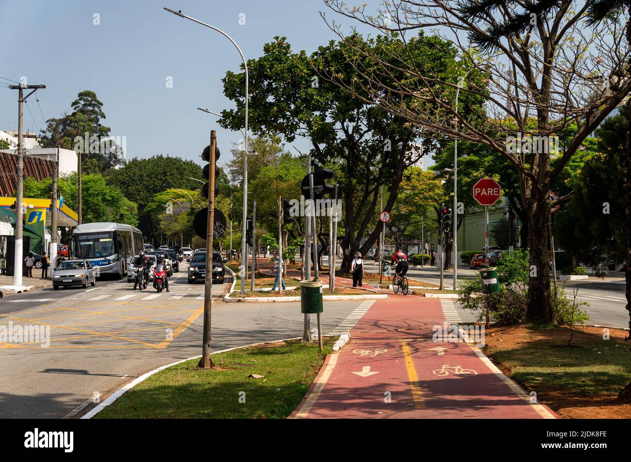 View of the bicycle lane running on the median strip of Sumare avenue at the crossing with Irmao Karmam square street in a normal business day. Stock Photo