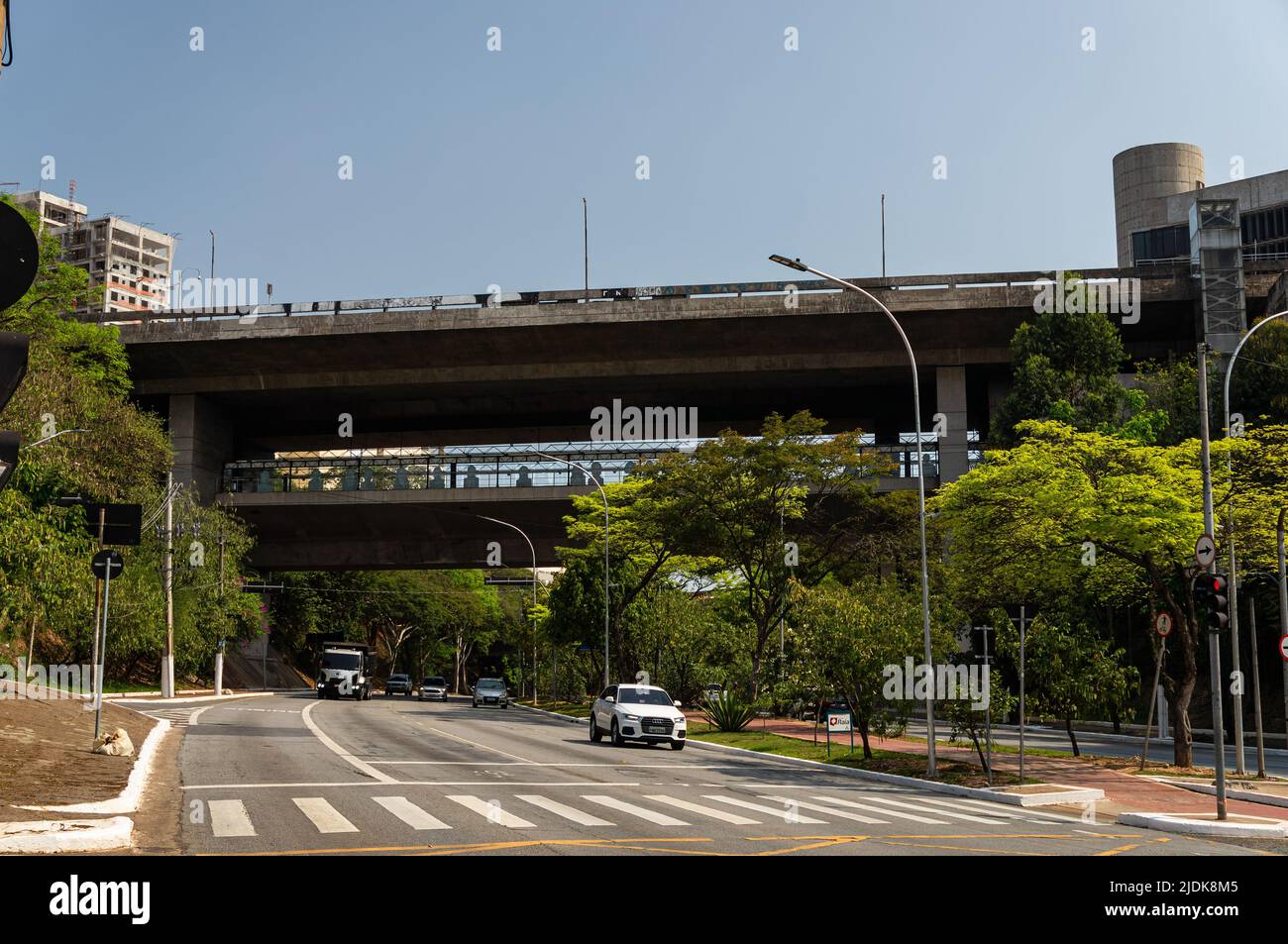 View of Capitao Adalberto Mendes viaduct over Paulo VI avenue and partial view of Sumare metro station (Line 2 - green) right below under sunny sky. Stock Photo