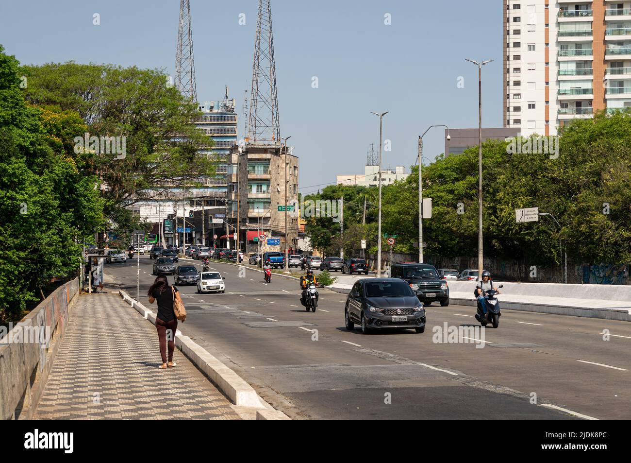 Oncoming traffic passing by Doutor Arnaldo avenue, over Capitao Adalberto Mendes viaduct in a normal business day under sunny clear blue sky. Stock Photo