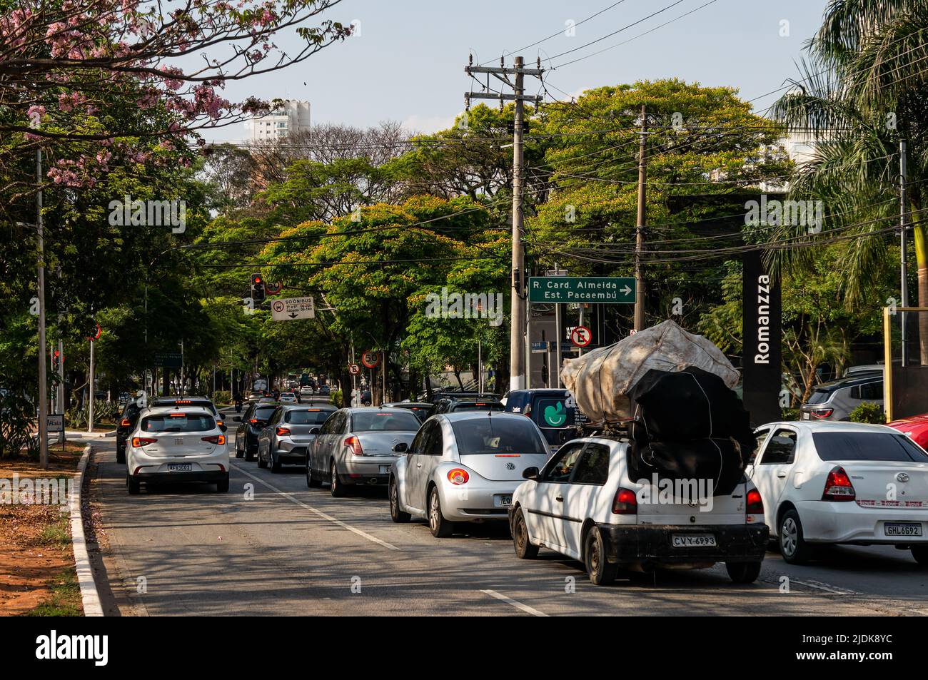 Cars stopped at the red traffic light at the crossing of Sumare avenue with Professor Joao Arruda street in a normal business day under clear blue sky Stock Photo