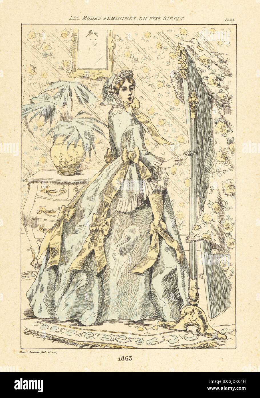 Fashionable lady in a parlor with palm pot plant, Paris, 1863. In hat tied with ribbon, gown with fitted bodice, full skirts, decorated with ribbons. Standing in front of a mirror in a room with floral wallpaper. Handcoloured drypoint or pointe-seche etching by Henri Boutet from Les Modes Feminines du XIXeme Siecle (Feminine Fashions of the 19th Century), Ernest Flammarion, Paris, 1902. Boutet (1851-1919) was a French artist, engraver, lithographer and designer. Stock Photo
