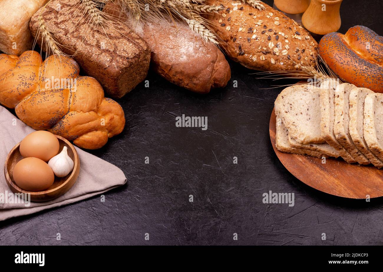 Different kinds of bread with whole grains on grey background Stock