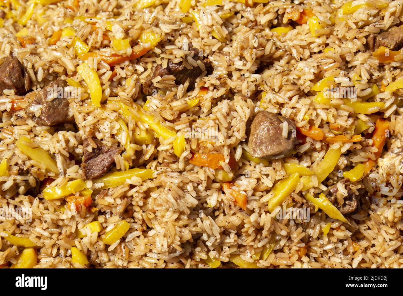 Folk oriental authentic traditional national cuisine in the form of pilaf with meat and vegetables. Stock Photo