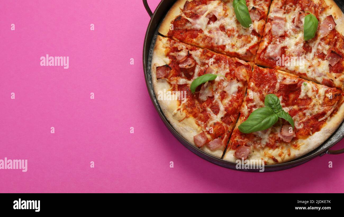 Pizza on pink background. Creative conception. Food delivery. Top view, flat lay, copy space Stock Photo