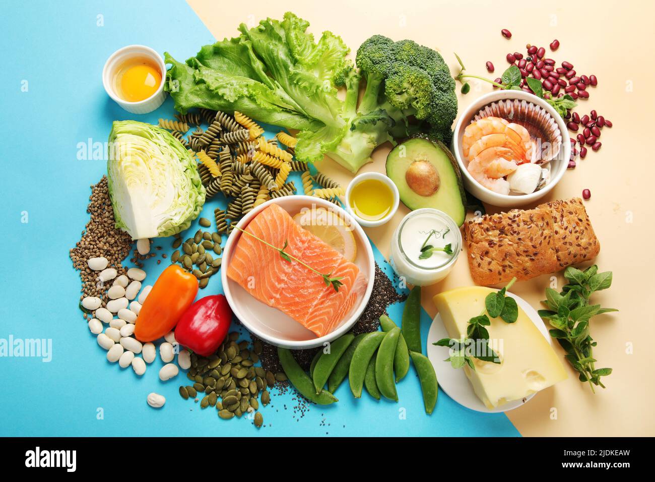 Pescatarian diet on colourful background. Vegetarian diet that includes fish or other aquatic animals. Flat lay, top view Stock Photo