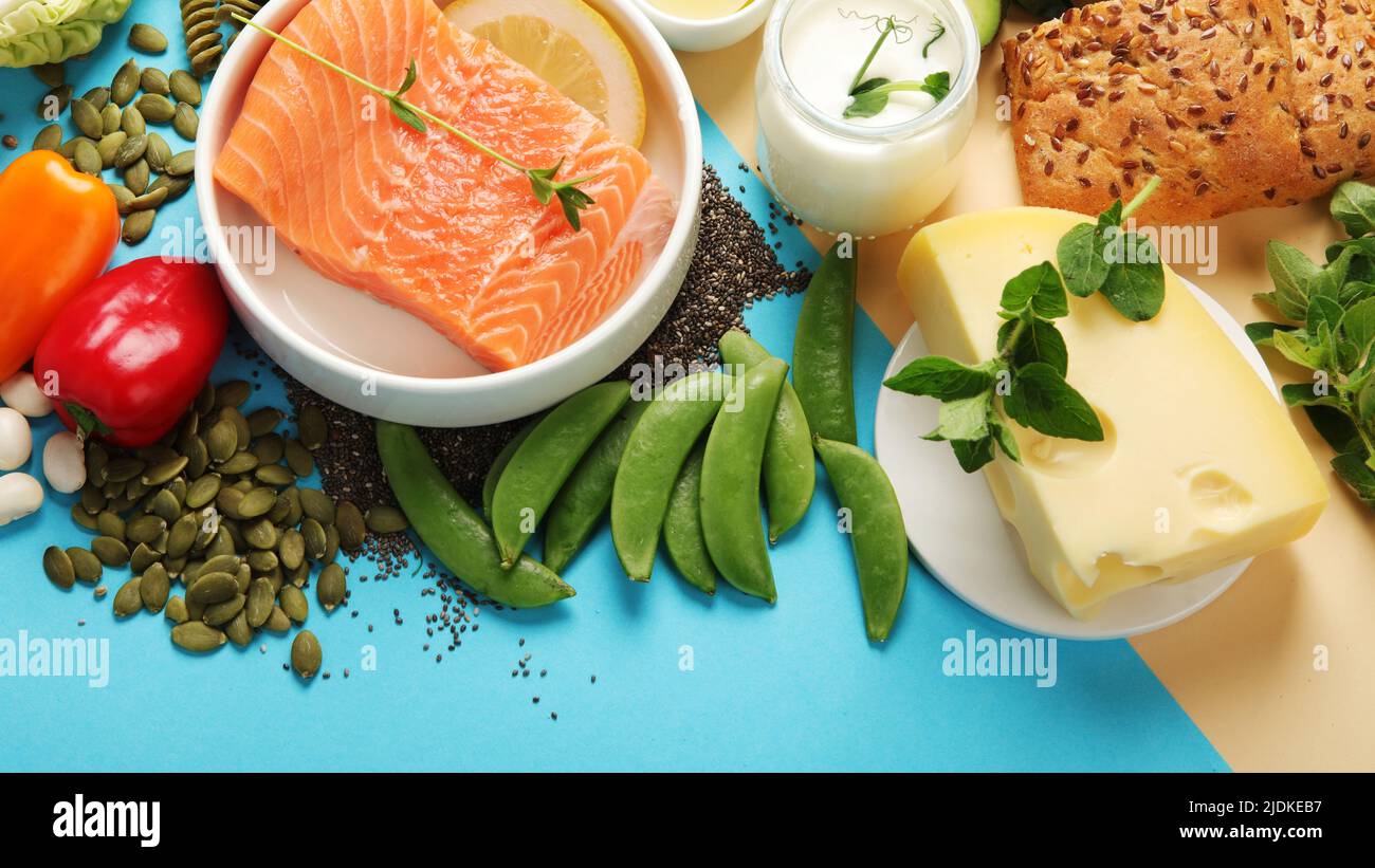 Pescatarian diet on colourful background. Vegetarian diet that includes fish or other aquatic animals. Flat lay, top view, copy space Stock Photo