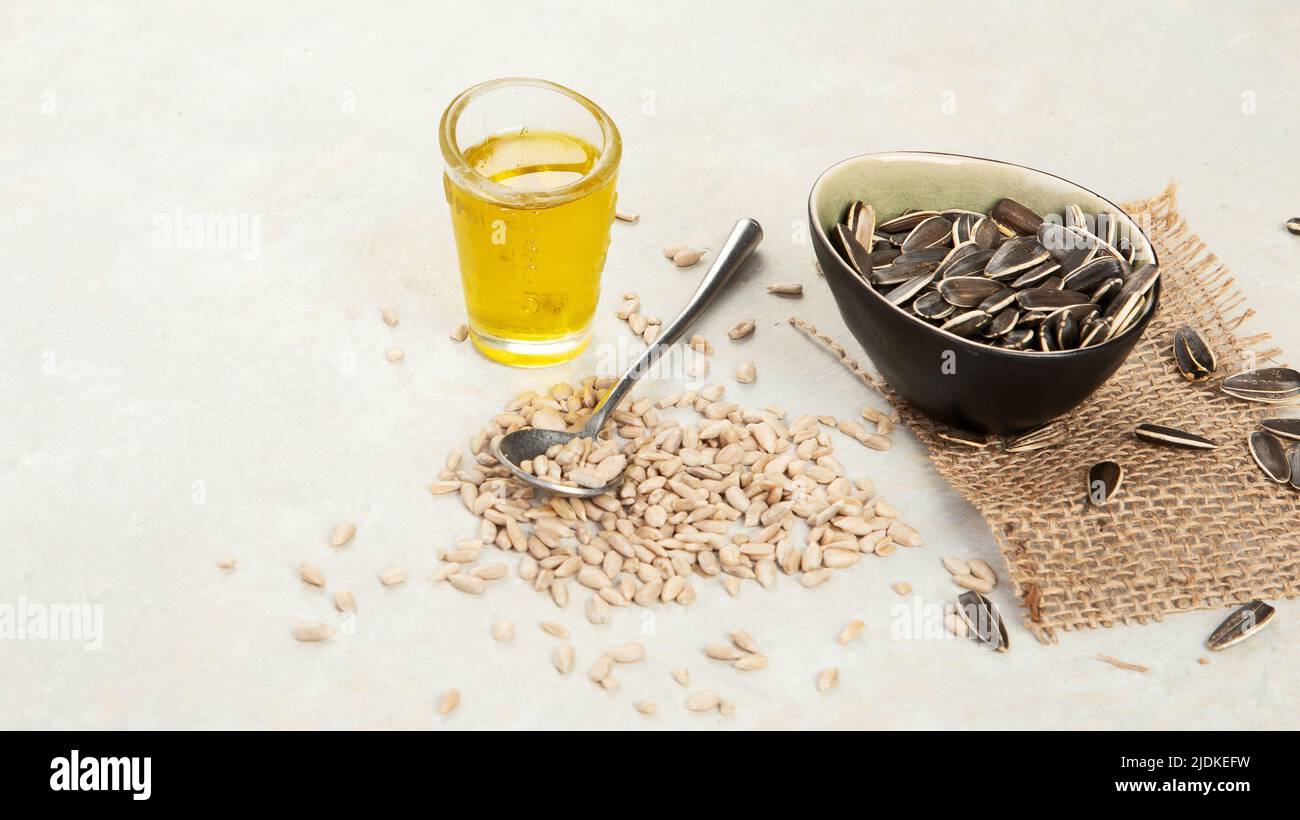 Sunflower oil and sunflower seeds on light background. Organic concept. Healthy food and fats. copy space Stock Photo