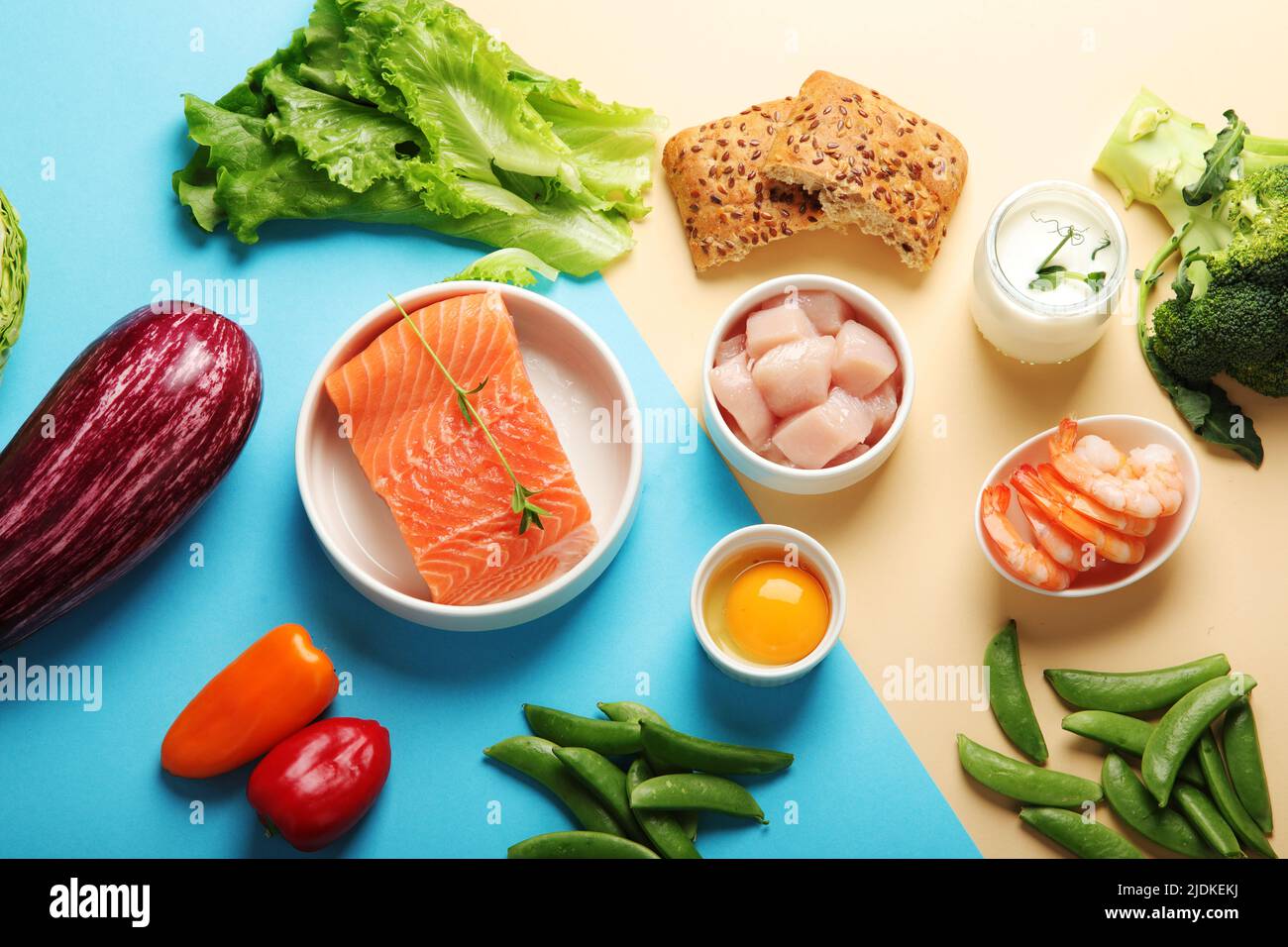 Pescatarian diet on colourful background. Vegetarian diet that includes fish or other aquatic animals. Flat lay, top view Stock Photo