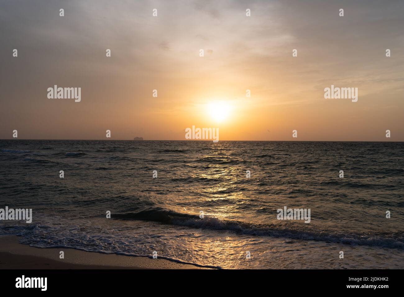 beautiful sunrise sky with waves on sea water Stock Photo - Alamy