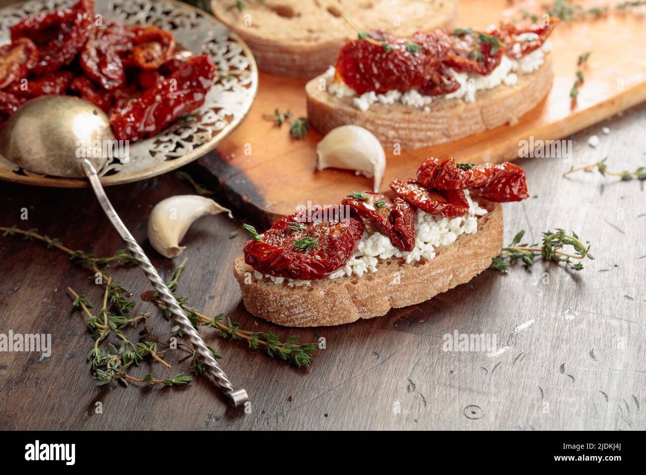 Bruschetta with ricotta, sundried tomatoes, and thyme. Traditional