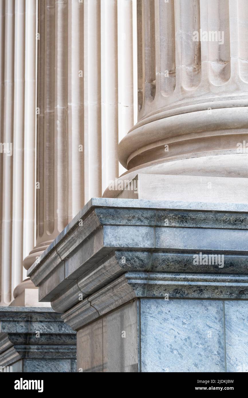 Low angled, tight crop view of architectural  Greek - Roman style columns on plinths standing side by side. Stock Photo