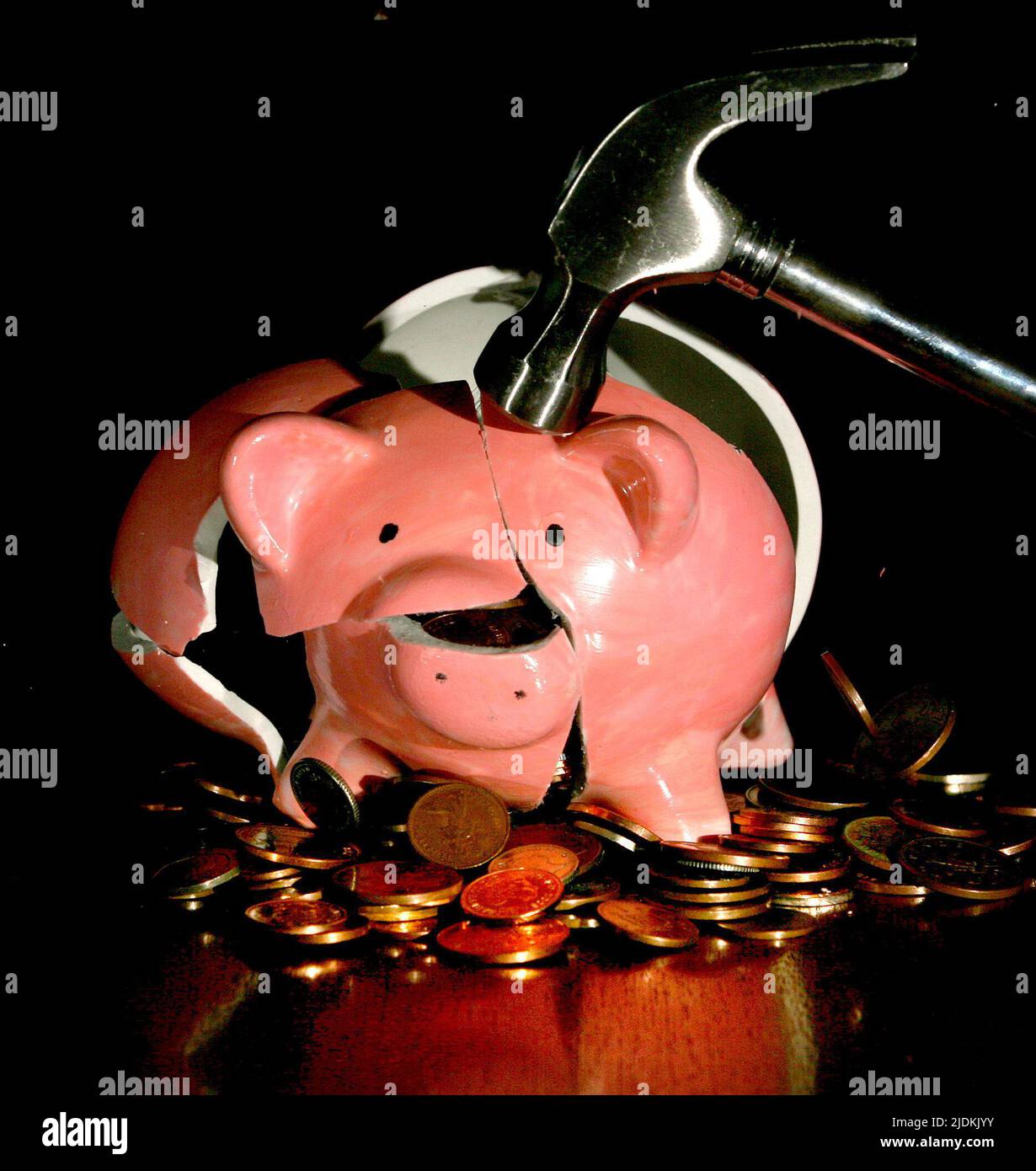 Undated file photo of a traditional piggy bank is smashed open with a hammer, as one in five (20%) people feel locked out of the financial system, a report has found. Stock Photo