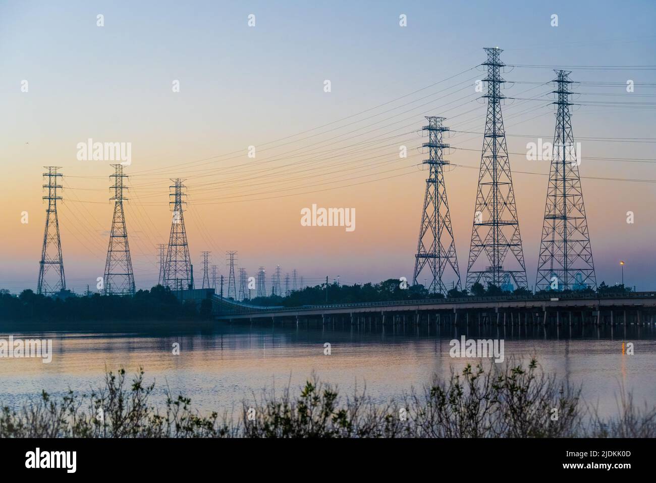 Transmission towers and a coal conveyor system at Blount Island on the St. Johns River in Jacksonville, FL, near the JEA Northside Generating Station. Stock Photo