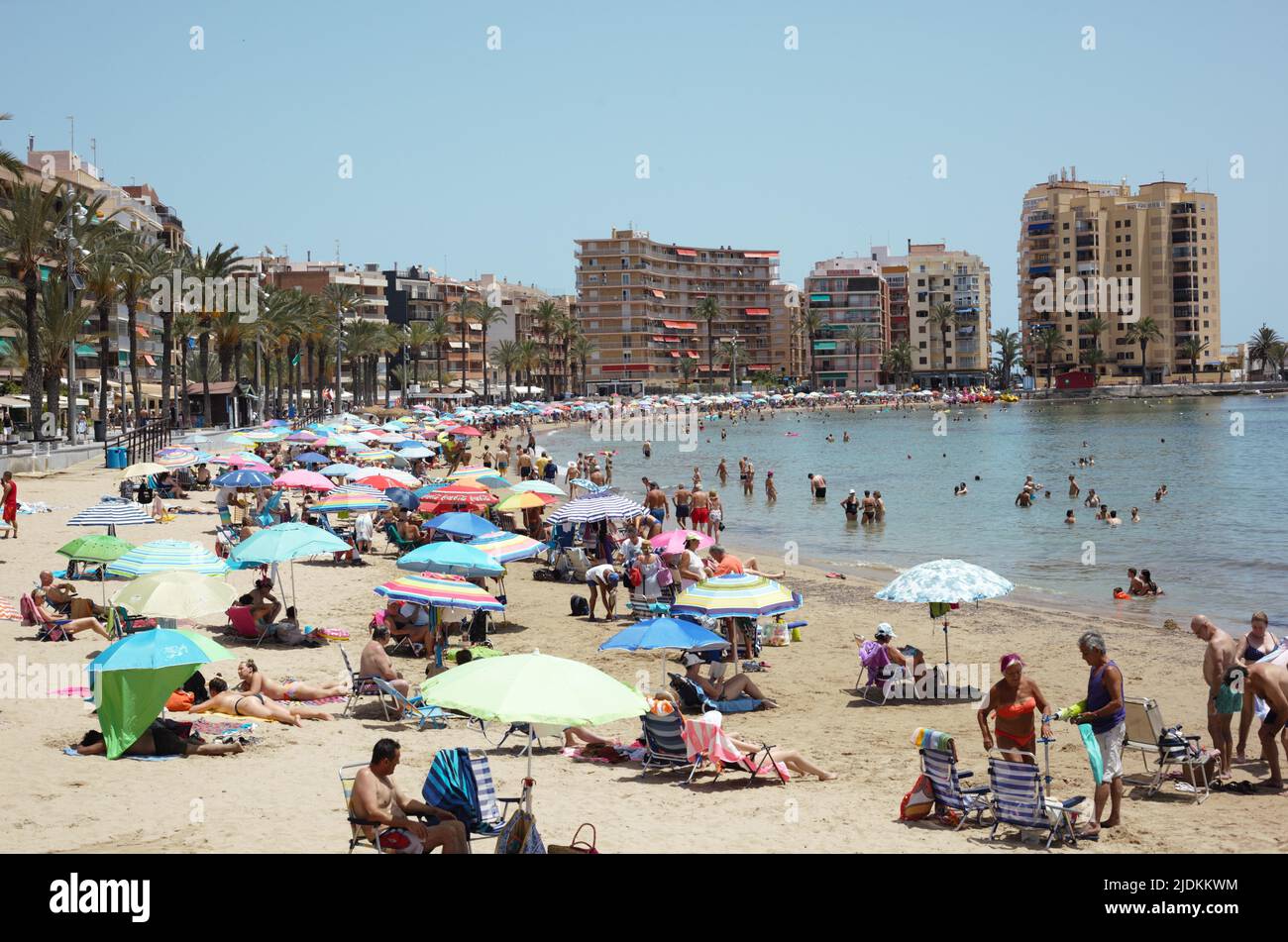 Crowded beach on the seafront of Torrevieja, Spain, June 2022 Stock Photo