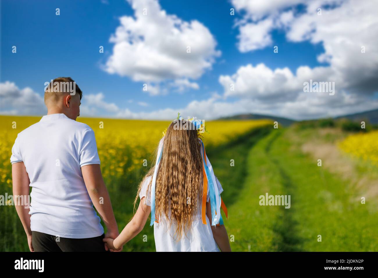 Rear view of happy carefree native children: older teenage brother and ...