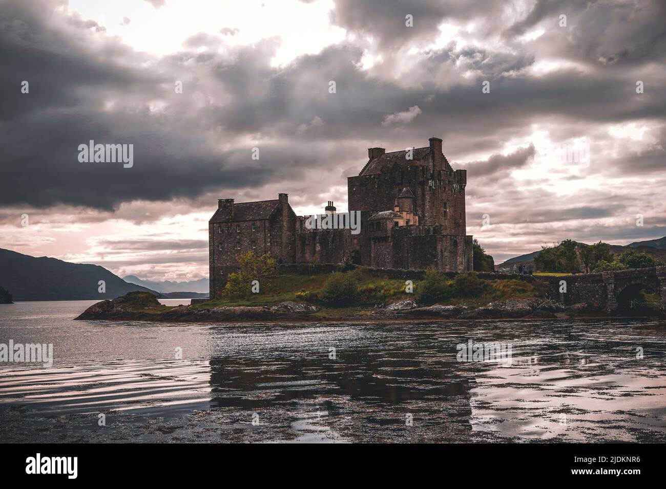 A photograph taken just before sunset at Eilean Donan Castle, in beautiful Scotland. Stock Photo