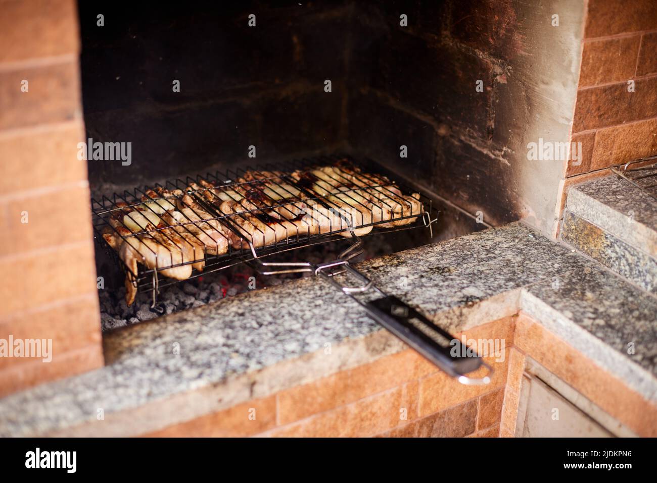 delicious grilled meat over charcoal barbecue Stock Photo - Alamy