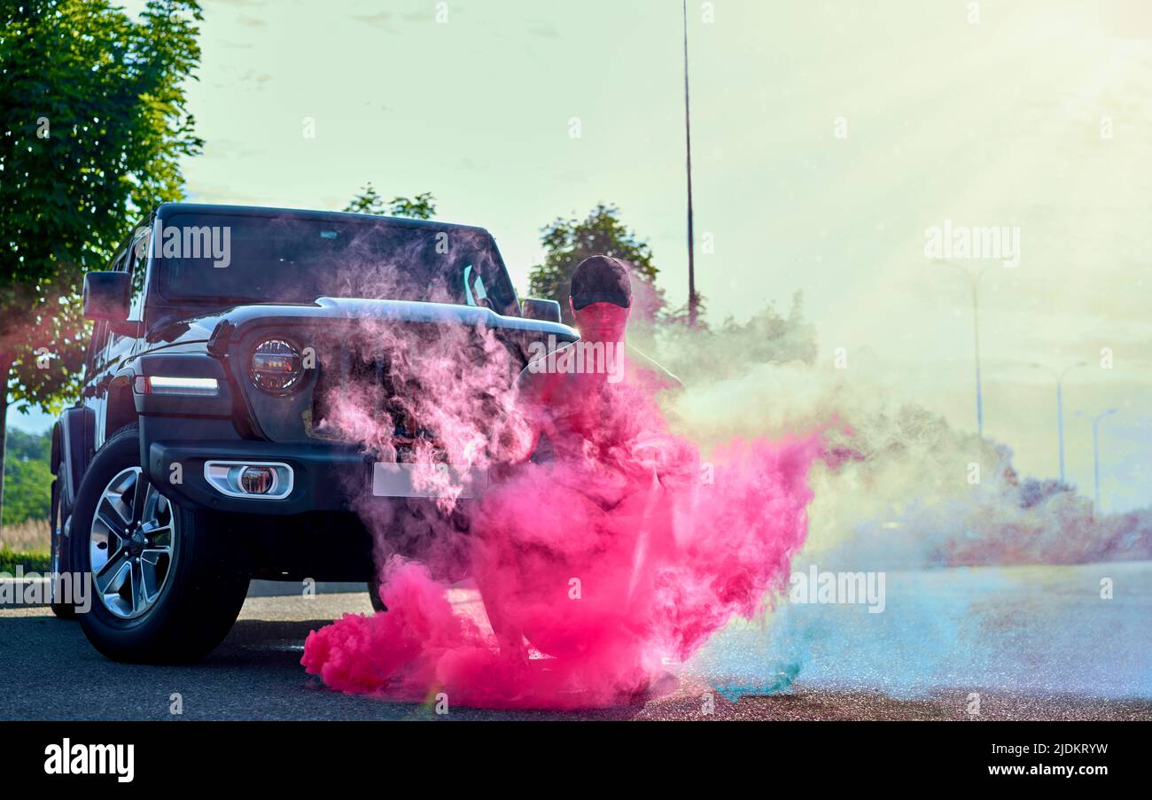 man with smoke bombs near the car Stock Photo Alamy