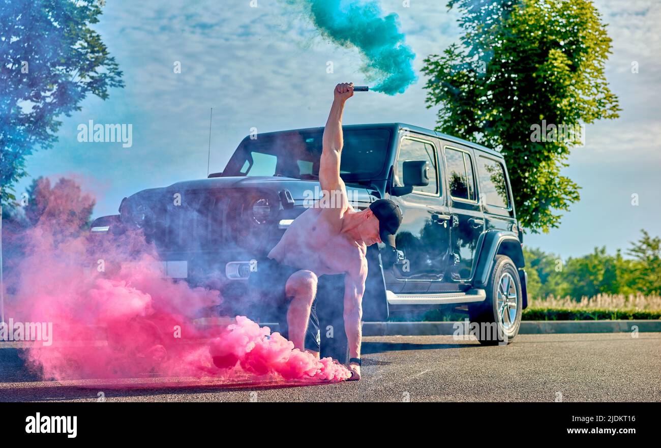 man with smoke bombs near the car Stock Photo Alamy