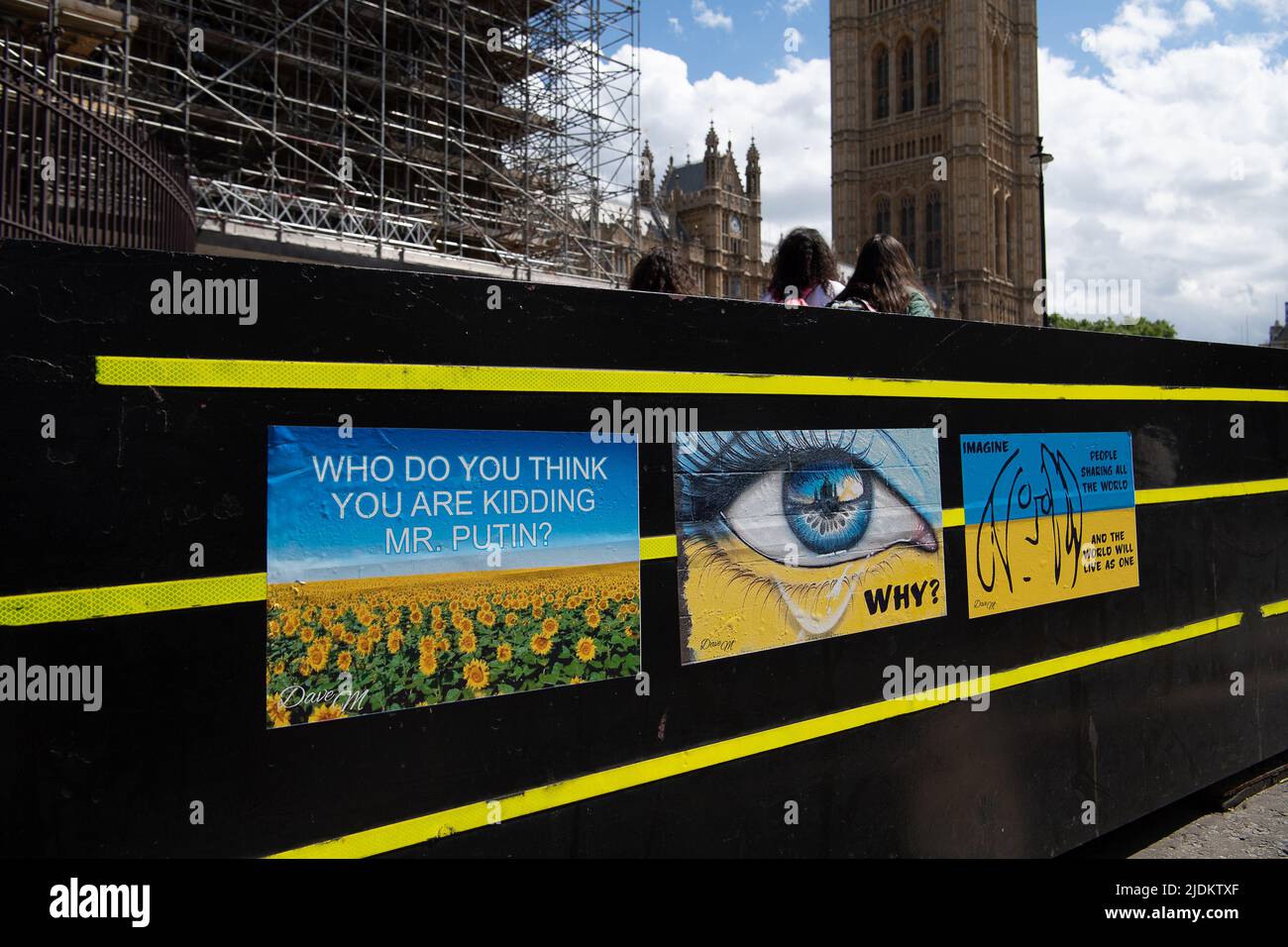 Westminster, London, UK. 8th June, 2022. Posters in the Ukrainian flag colours stuck to security barriers outside the House of Commons questioning the invasion of Ukraine by Russia. Credit: Maureen McLean/Alamy Stock Photo