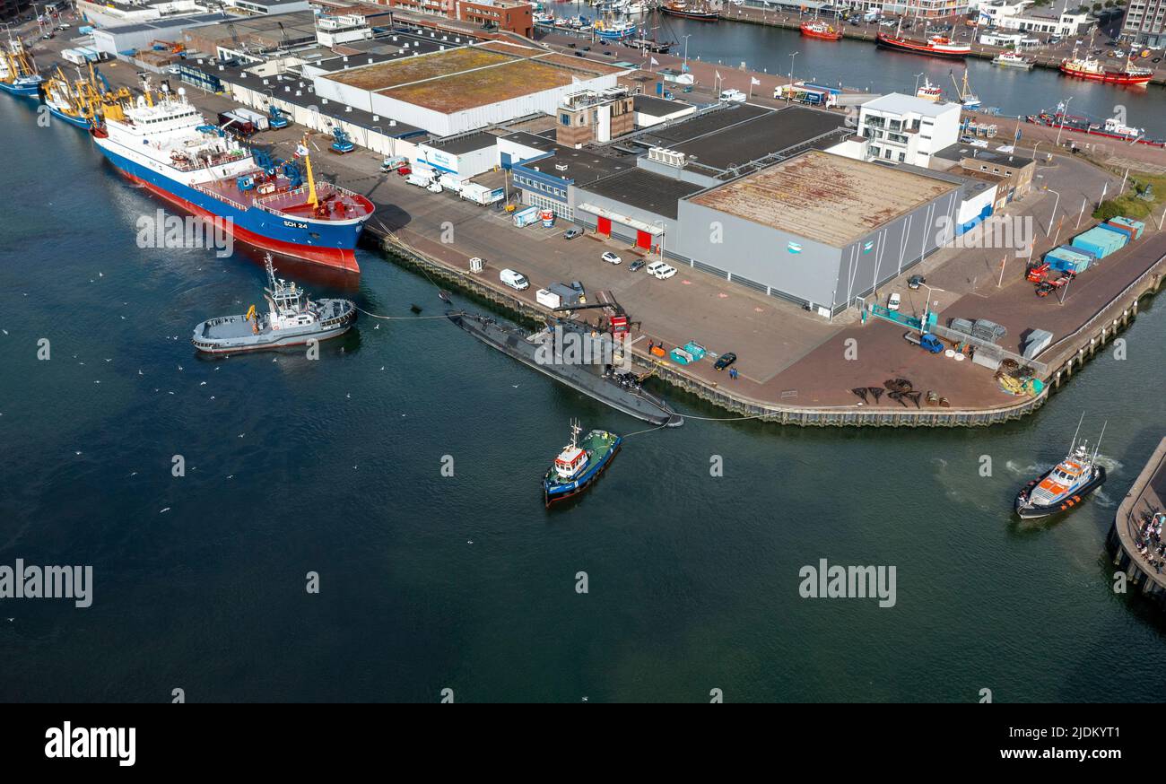 Aerial view of Zr. Ms.Zeeleeuw submarine leaving Scheveningen Harbor, escorted by a navy tugboat, pilot boat & lifeboat, South Hollands, Netherlands. Stock Photo