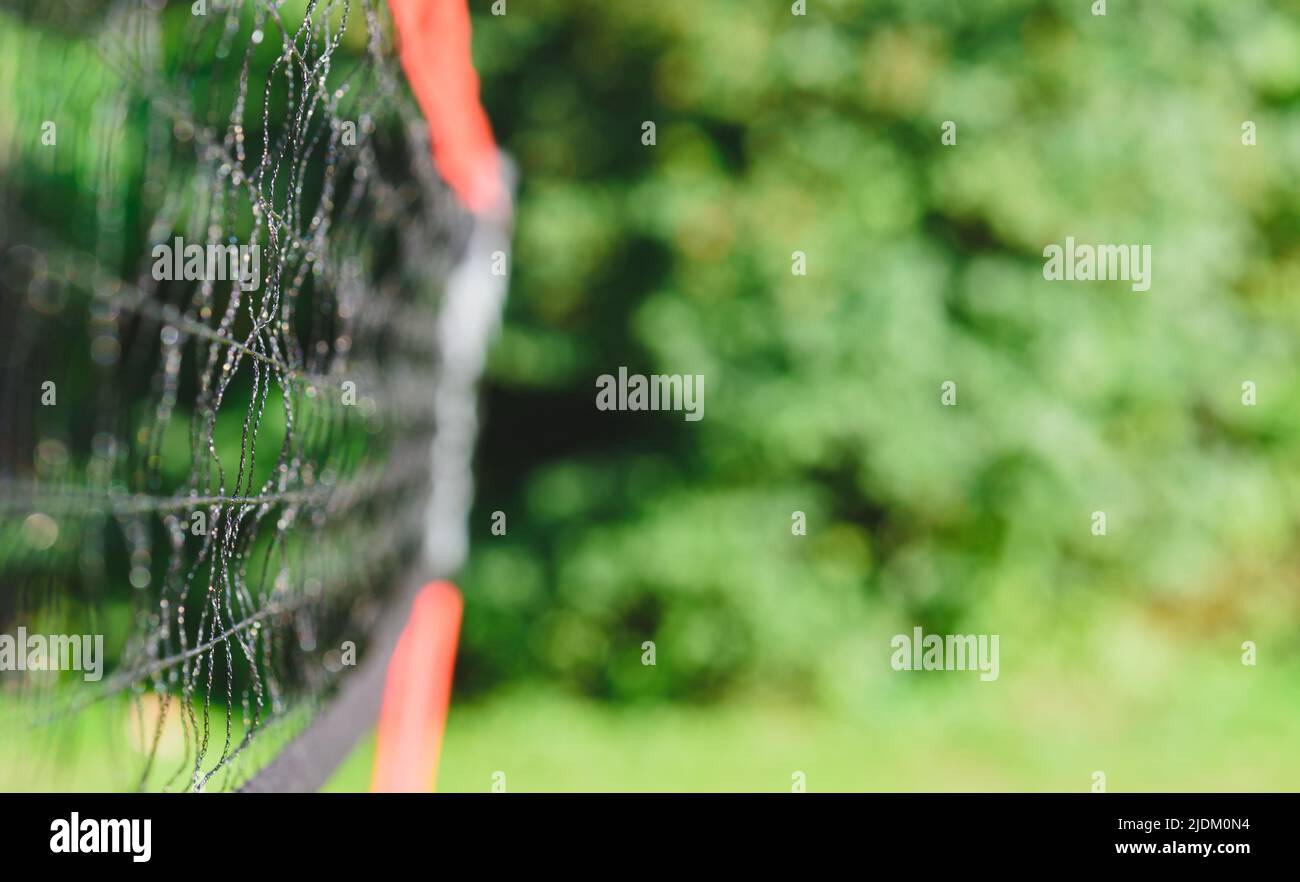 Outdoors background with net for casual badminton on sunny summer day at backyard Stock Photo