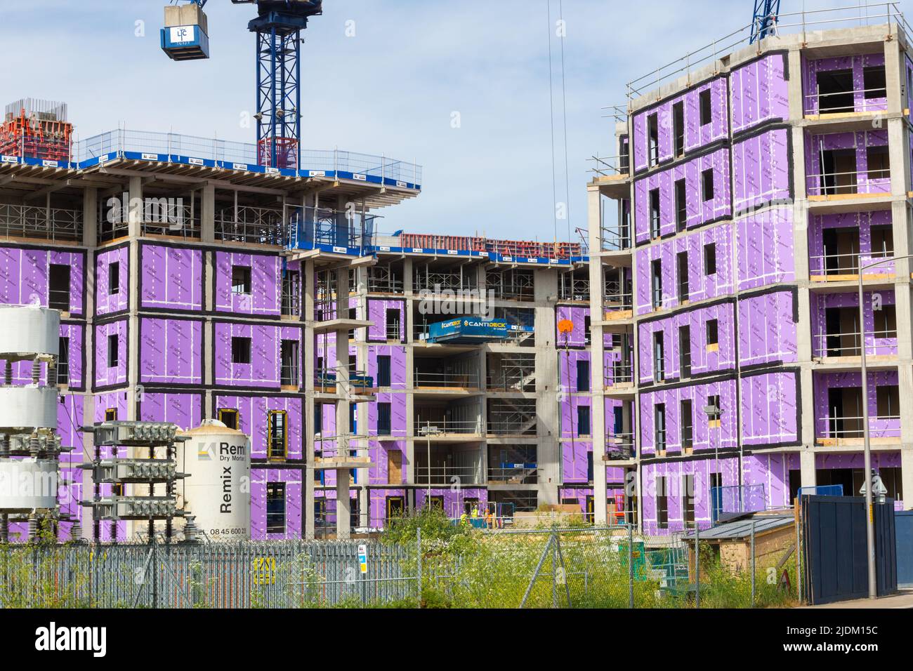 Construction site, new tower apartment buildings, siniat weather defence purple wrap over building, ashford, kent, uk Stock Photo