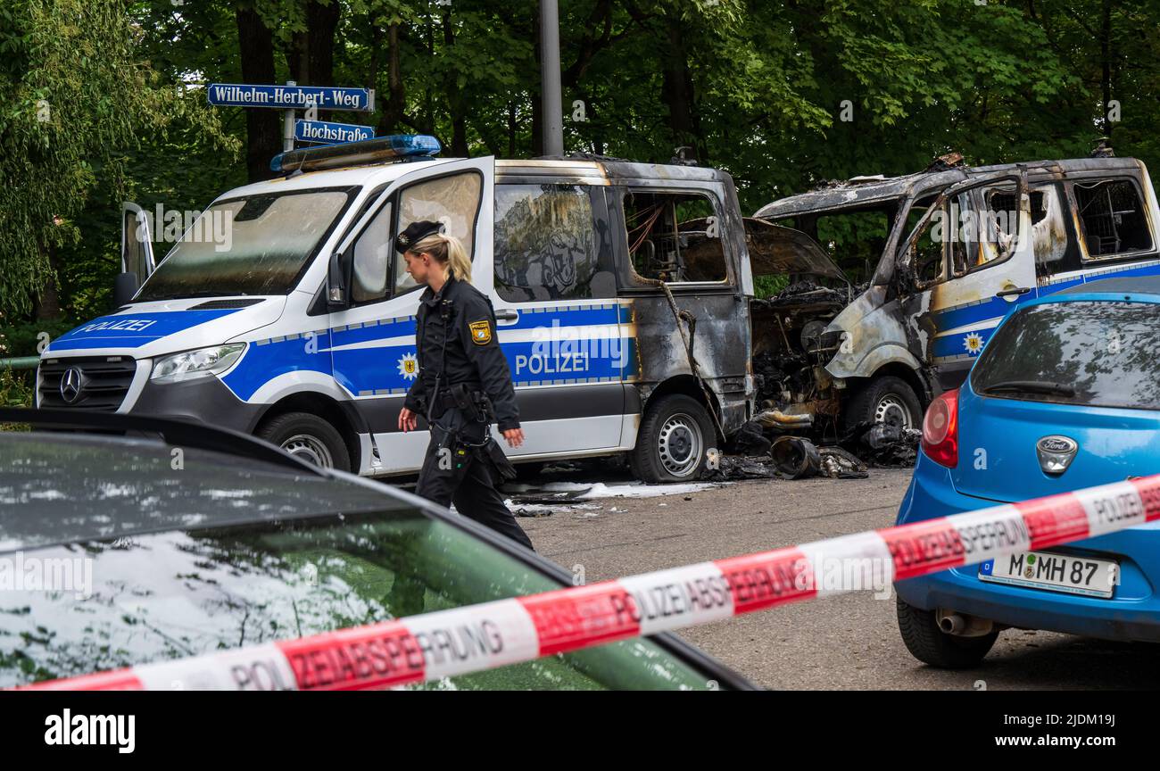 Munich, Germany. 22nd June, 2022. A policewoman walks past police cars ...