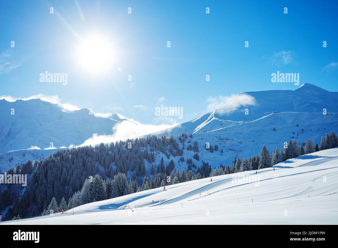 Winter alpine landscape with ski track and bright sunlight Stock Photo