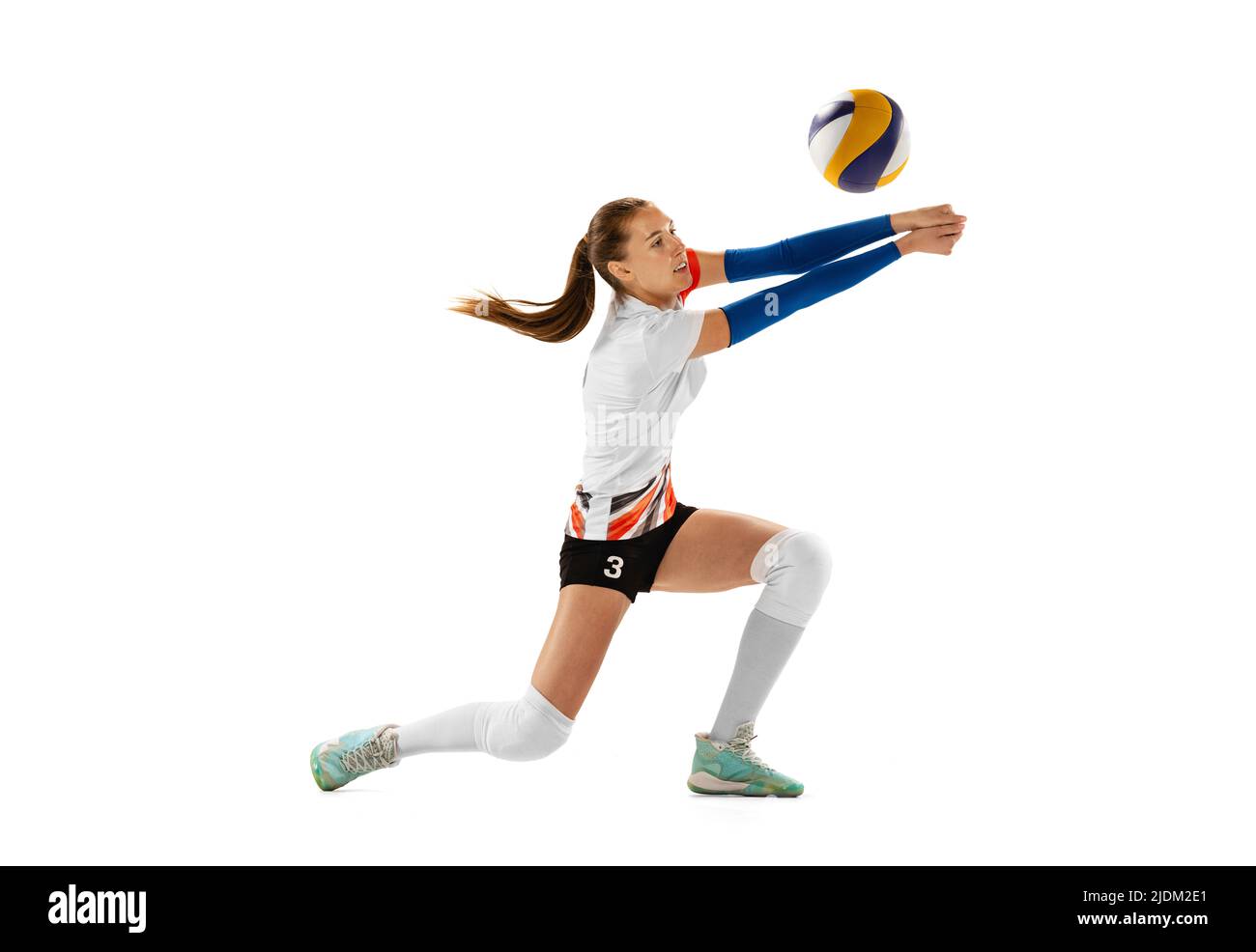 Female professional volleyball player in sports uniform training with ...