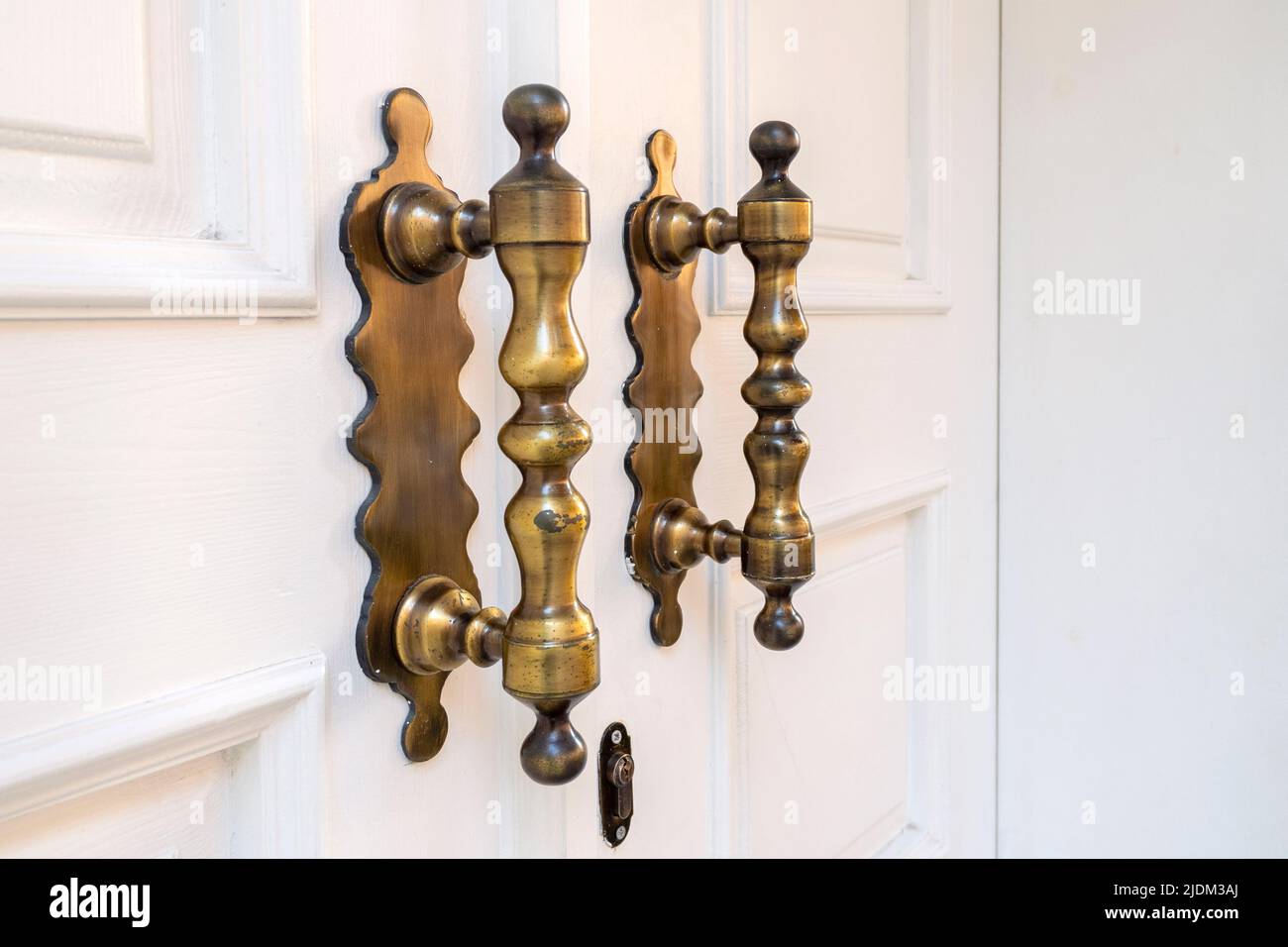 Elegance long door handle on wooden white door Stock Photo Alamy