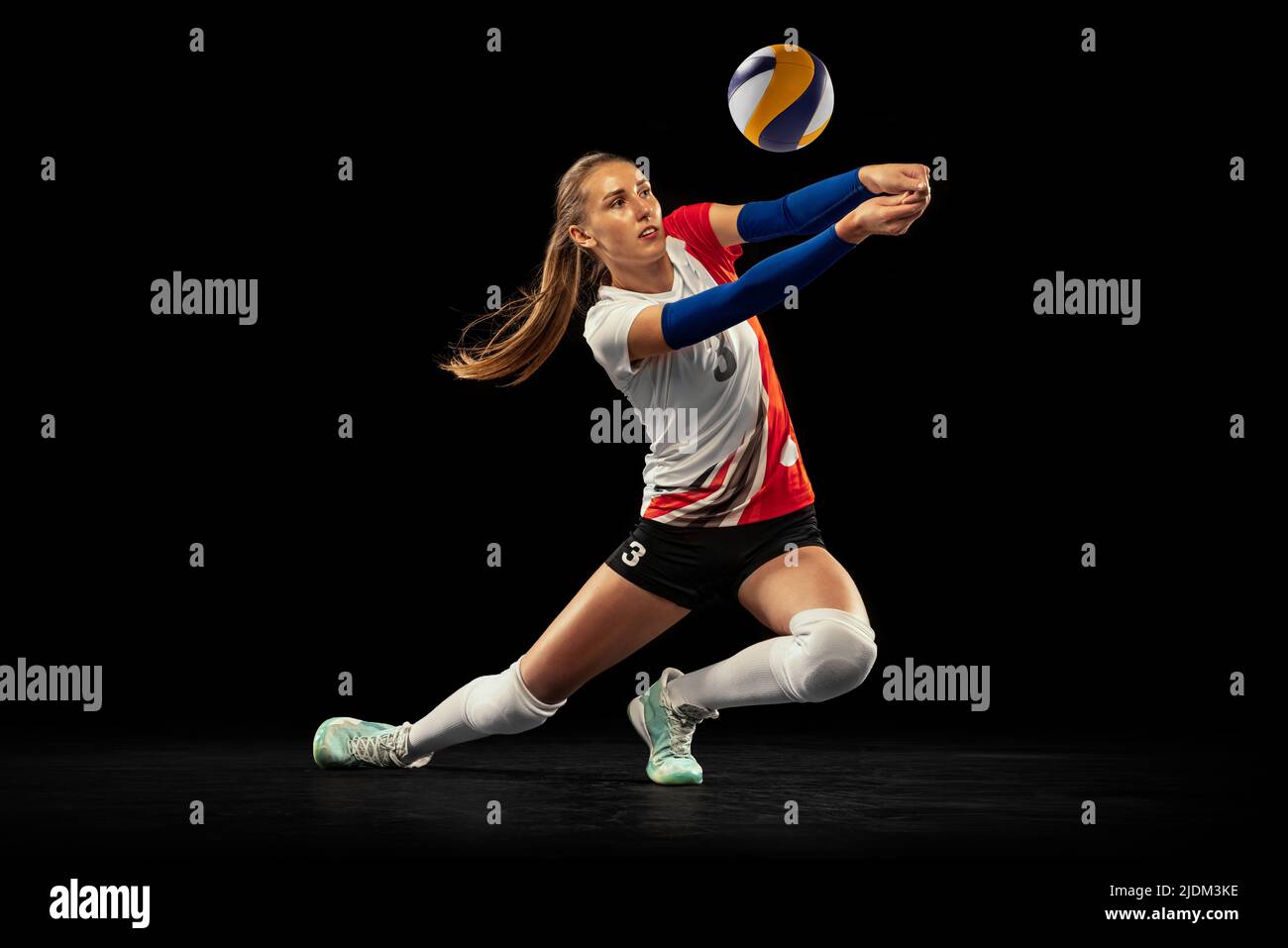 Dynamic portrait of professional volleyball player in sports uniform