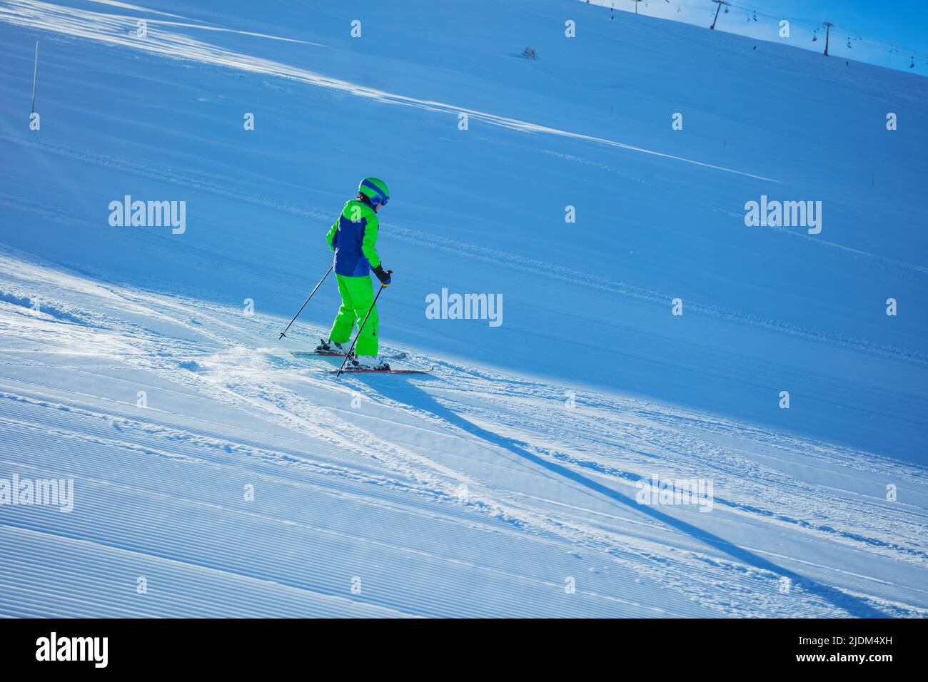 Action photo of a boy ski downhill fast view behind Stock Photo Alamy