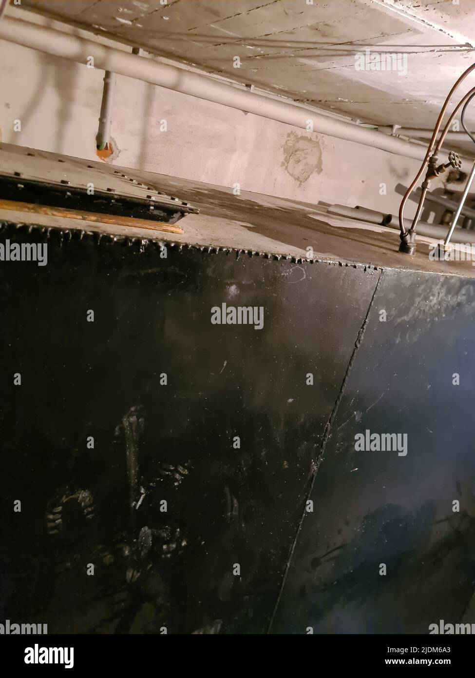 Old heating oil tank in dingy dank basement Stock Photo Alamy