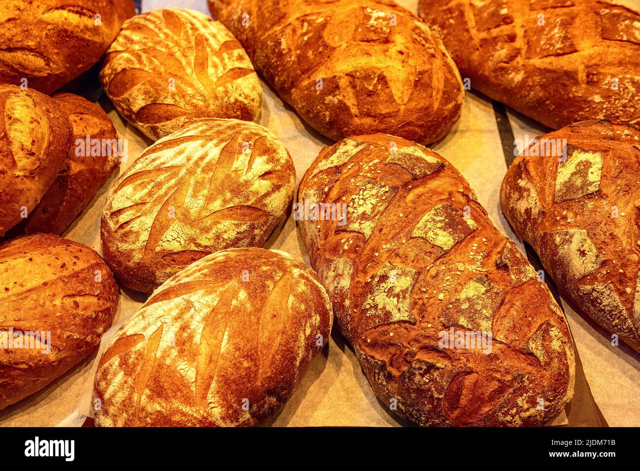 Fresh bread with crispy crust in the bakery top view. Freshly baked goods closeup. Stock Photo