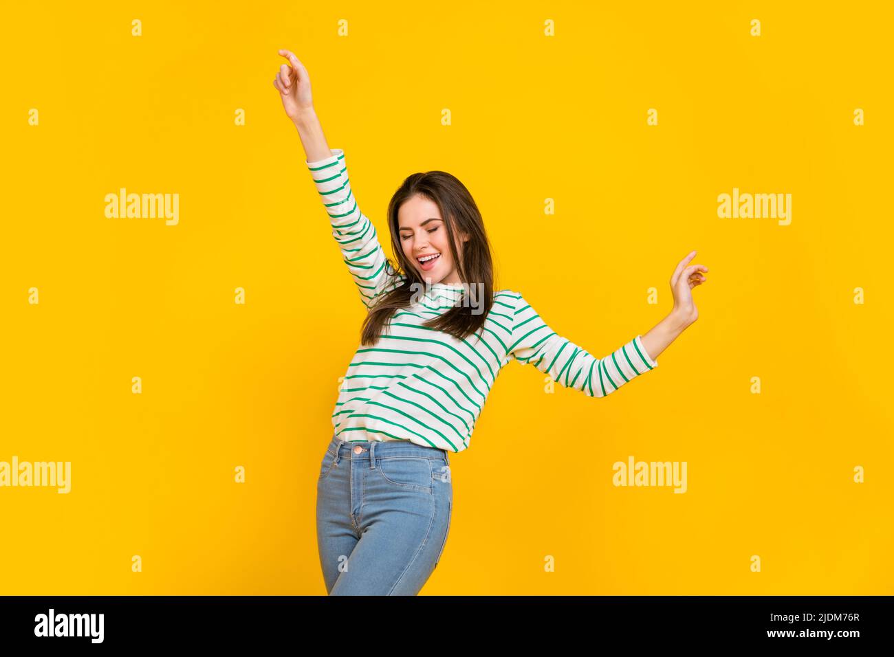 Photo of adorable stunning female dancing spend free time in club wear striped shirt isolated on yellow color background Stock Photo